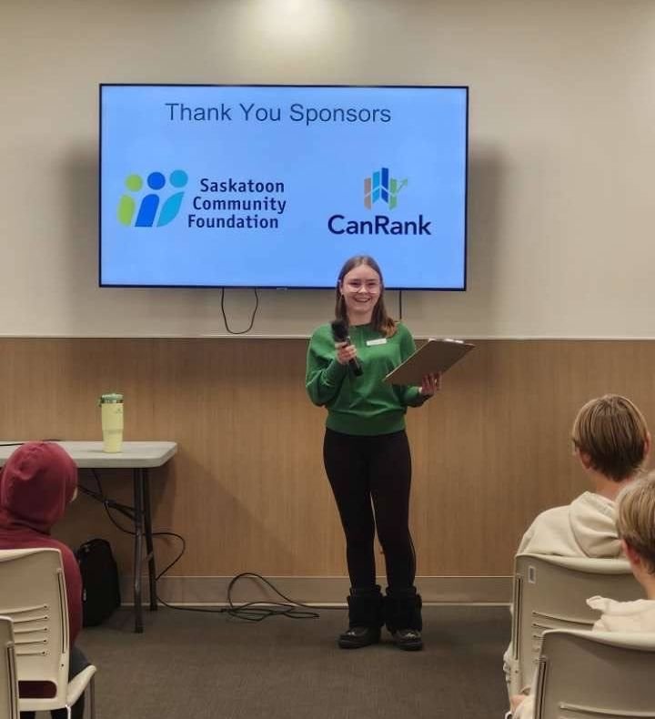 100 Youth Who Care YXE committee member thanking sponsors at a past meeting